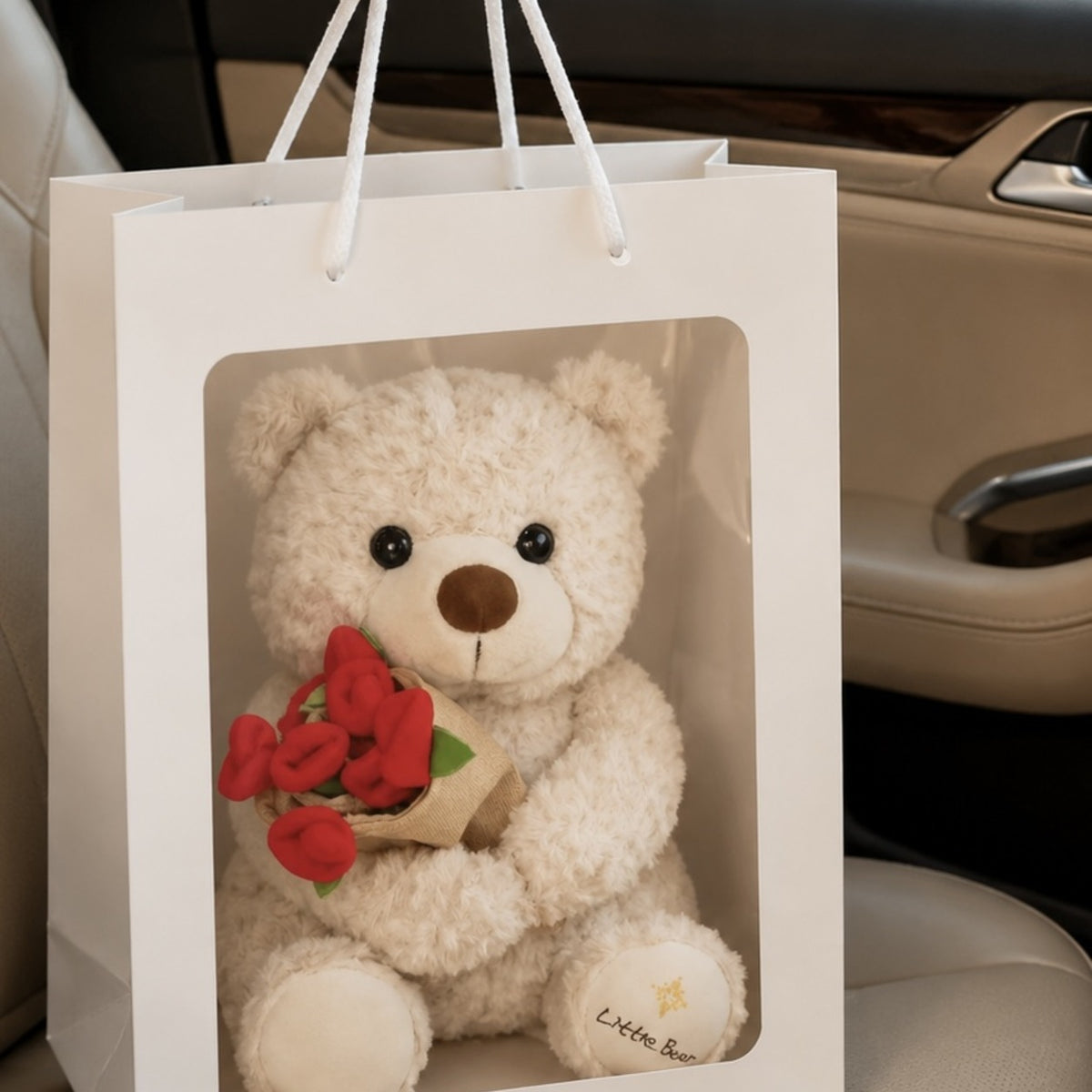 Teddy bear and red rose bouquet gift displayed in gift bag